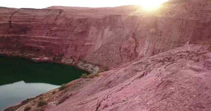 Travelers tourist at Hidden lost spring lake in desert negev of Israel Agam timna. Aerial shoot above desert Oasis at Timna, Orange Red cliff brown mountain rocks in the middle of the Arava mountains