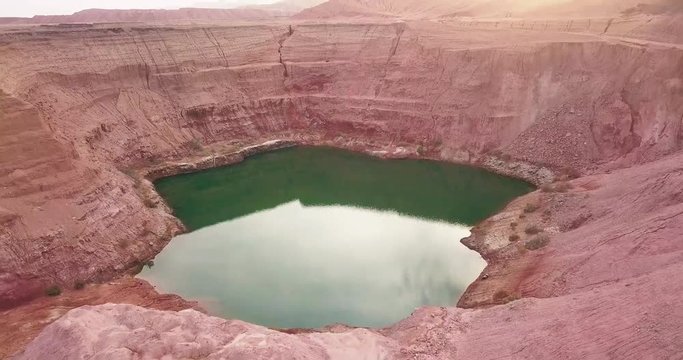 Hidden lost spring lake in desert negev of Israel Agam timna. Aerial shoot above desert Oasis at Timna, Orange Red cliff brown mountain rocks in the middle of the Arava, Kibbutz Samar Eilat springs