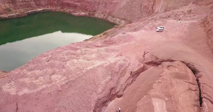 Travelers tourist at Hidden lost spring lake in desert negev of Israel Agam timna. Aerial shoot above desert Oasis at Timna, Orange Red cliff brown mountain rocks in the middle of the Arava mountains