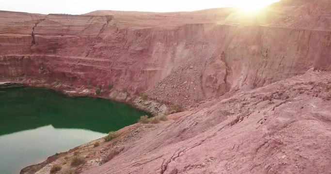 Travelers tourist at Hidden lost spring lake in desert negev of Israel Agam timna. Aerial shoot above desert Oasis at Timna, Orange Red cliff brown mountain rocks in the middle of the Arava mountains