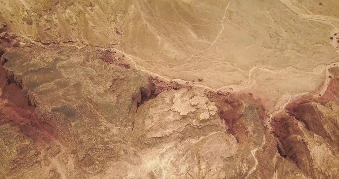 Aerial view over Negev desert of Israel. Arava Desert In South Israel. Top hill rock mountains blue sky and clouds.