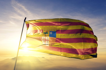 Aragon of Spain flag waving on the top sunrise mist fog - obrazy, fototapety, plakaty