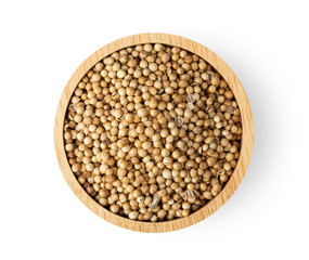 Coriander seeds in wood bowl isolated on white background. top view