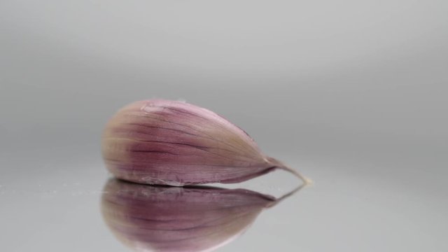 garlic clove on rotating plate, closeup studio shot