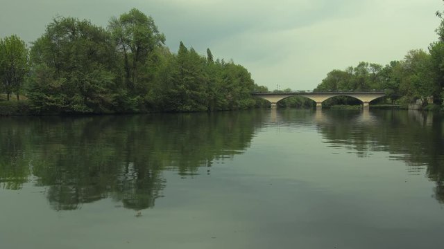 A slight overcast hangs over a calm river in Cognac, France.