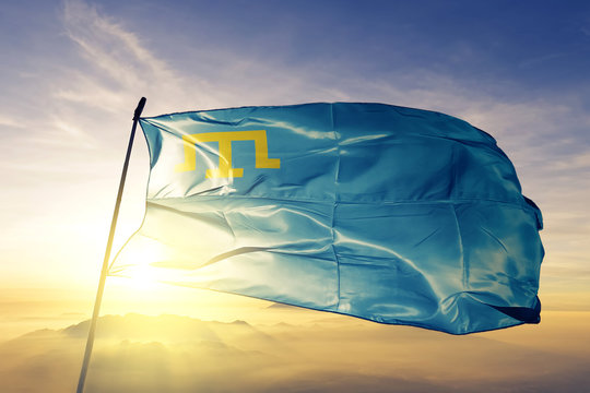 Crimean Tatars Crimeans flag waving on the top sunrise mist fog