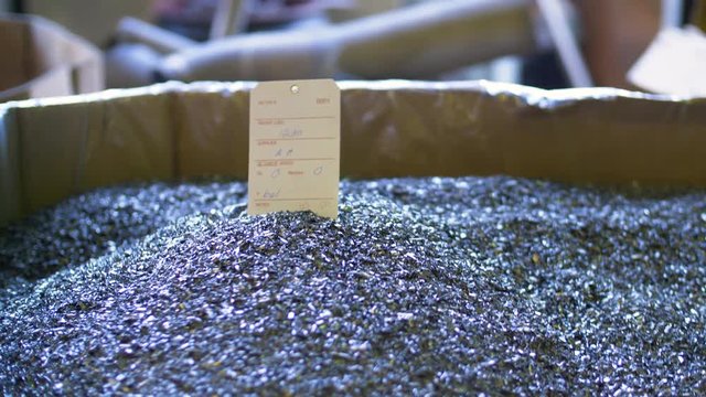 A box of tiny metal pieces with paper label sticking out