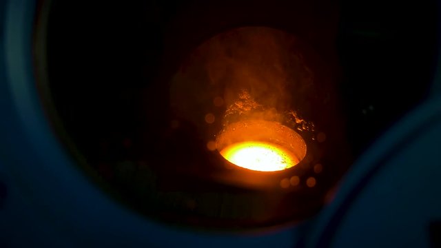 Glowing hot fused metal in a plasma arc furnace
