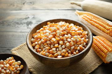 many corn seeds in the bowl put on the mat with corn sheath, Back light food concept.