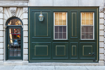 Green paneling on side of classic architecture