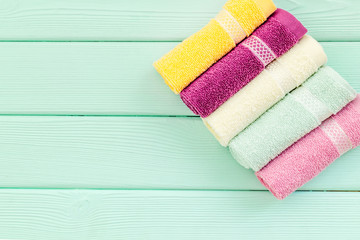 high quality cotton towels set on mint green wooden background top view mock up