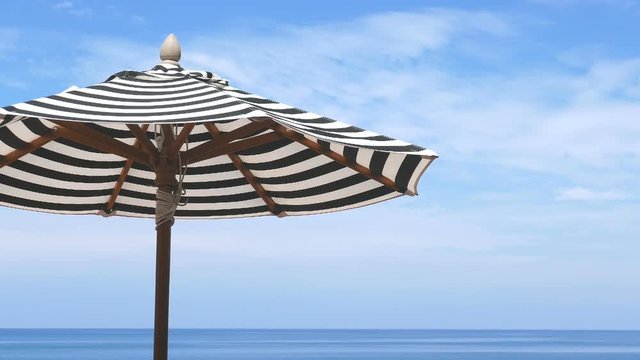 Detail of a striped beach umbrella under the sun