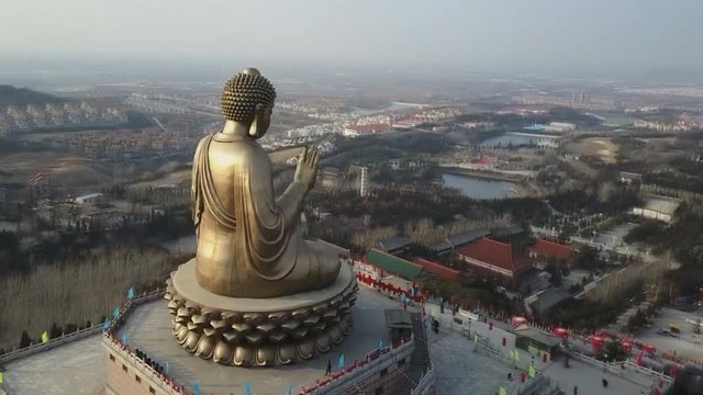 The Nanshan great Buddha. The world's largest bronze Buddha. It is 38m high. Longkou, China (aerial photography)