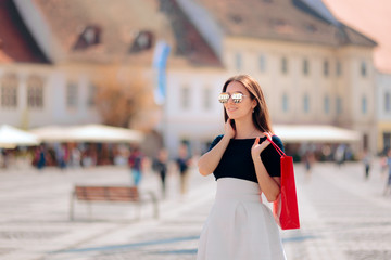 Fototapeta premium Tourist Woman with Shopping Bag Visiting Touristic Destination