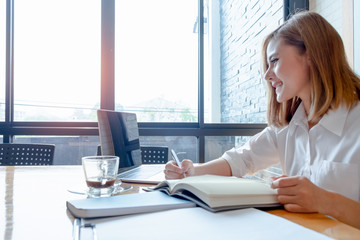 Young businesswoman work with mobile phones and notebooks in the office, business concept