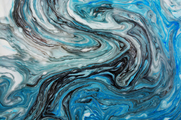 Abstract beautiful blue marble pattern with black color.The Eastern style of Ebru painting on water with acrylic paints swirls.A stylish mix of colors,natural luxury.