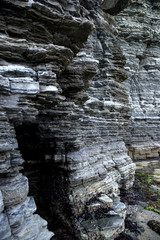 Dinosaur Footprint and sedimentary rocks in famous tourist site Sangjogam County Park in Goseong County, South Korea.
