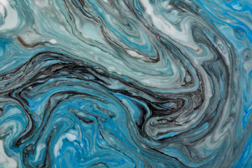 Abstract beautiful blue marble pattern with black color.The Eastern style of Ebru painting on water with acrylic paints swirls.A stylish mix of colors,natural luxury.