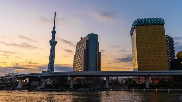 Night to day time lapse of Tokyo skyline on the Sumida River at night, Japan