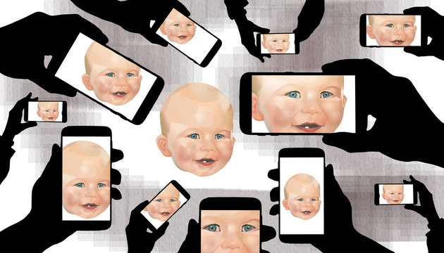 A baby draws the full attention of family members who record his image on their cell phones.