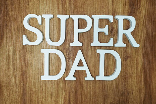 Super Dad Word alphabet letters on wooden background