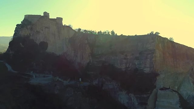 Beautiful aerial view of one of the most beautiful castles in Emilia Romagna, during a day with a clear blue sky and the bright sun, the fortress of San Leo