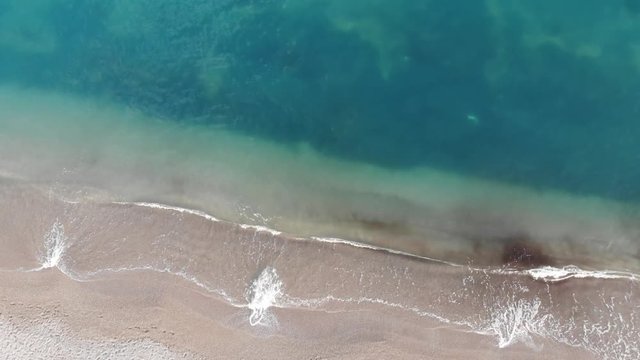 Drone landing on the beautiful beach, aerial view 4k shot.