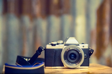 Old school retro camera with rusty blured background with bokeh