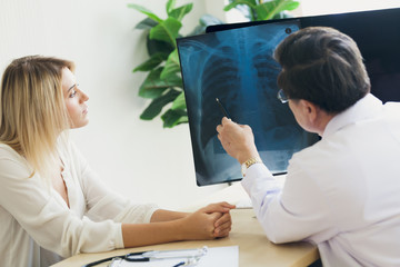 The doctor is describing the X-ray scan of the female patient's chest.