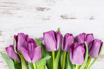 Bouquet of purple tulips for different occasions on rustic boards, copy space for text