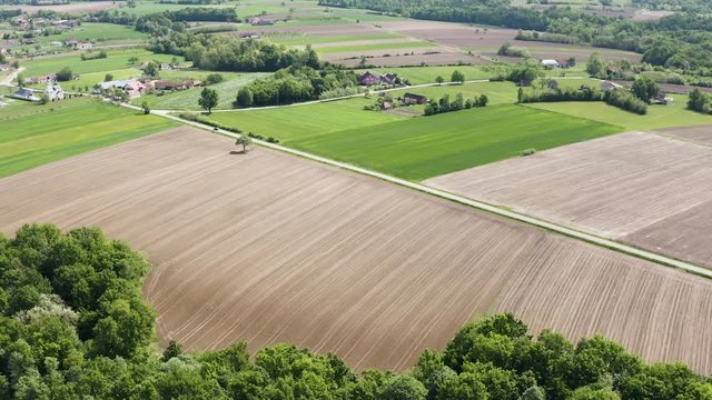 Cinematic drone footage when filming beautiful nature and road where car is passing.Man is driving his car to capture cinematic move,impressive Bosnia and Herzegovina and very organize village.