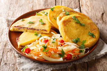 Tasty vegetarian pupusas recipe served with curtido closeup on a plate. horizontal