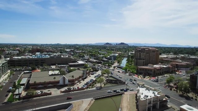 Aerial slow ascent over the traffic in old town Scottsdale at the intersection of Scottsdale Road and Camelback, Scottsdale, Arizona. Concept: transportation,traffic,urban living