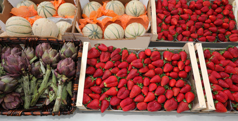 stall of the greengrocer with boxes full of fruits and vegetable