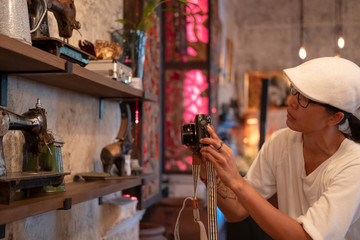 Happy Asian Tourist taking photo in cool bar