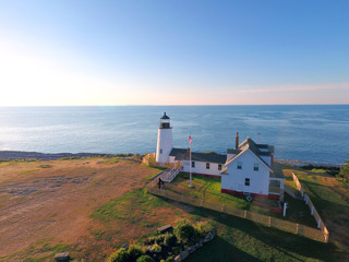 Fototapeta na wymiar New England Lighthouse Along Coastline in Early Morning