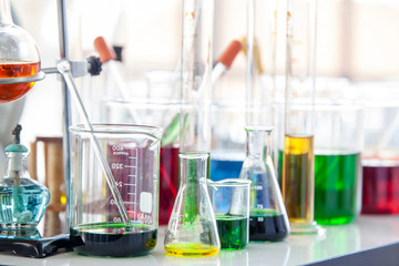 Laboratory glassware with liquids of different colors