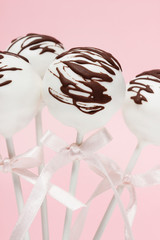 Chocolate cake pops on pink background.