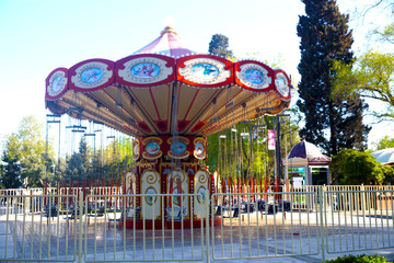 Children's bright carousel  in the center of the square close-up 
