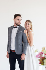 Wedding couple in love. Beautiful bride in white dress  and man handsome ,white  background