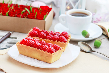 Raspberry cake and cup of coffee.