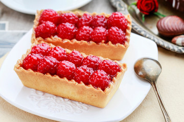Raspberry cake and cup of coffee.