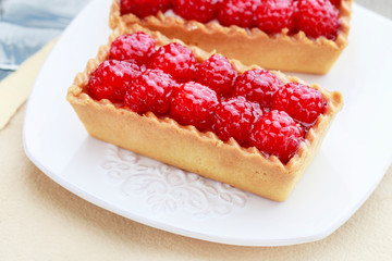 Raspberry cake and cup of coffee.