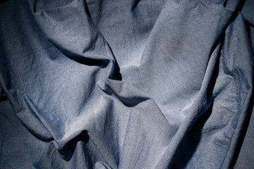 Fototapeta premium Dramatic lighting on denim fabric