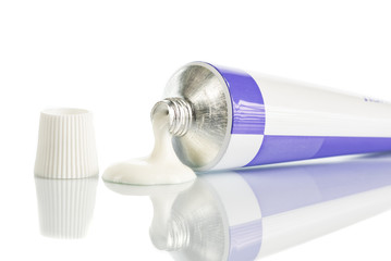 ointment for external use a little squeezed out of a tube on a white background, near the cover