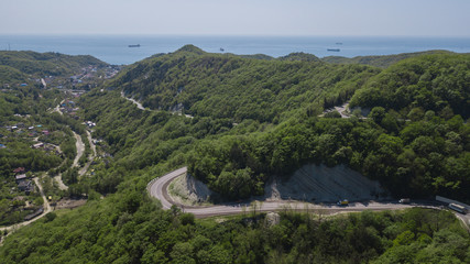 Fototapeta na wymiar Aerial view of a curved winding road to Sochi Russia trough the mountains