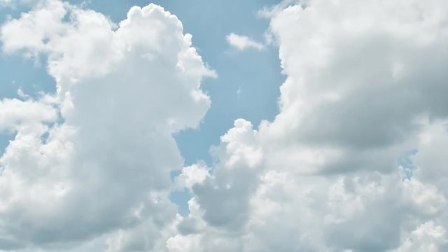 Beautiful cloudscape with large, building clouds and sunrise breaking through cloud mass.