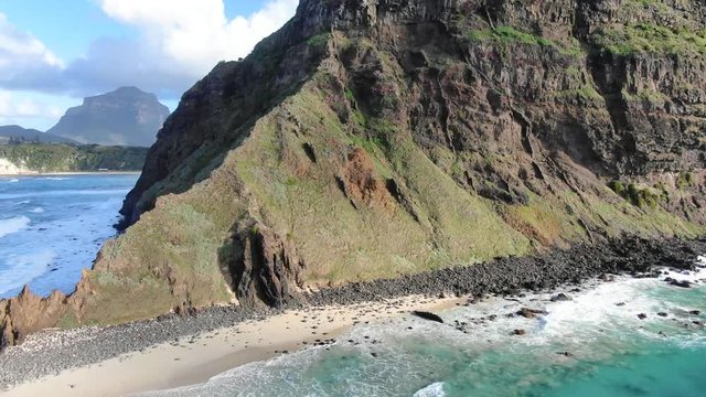 Aerial 4k drone footage of Lord Howe Island, a pacific subtropical island in the Tasman Sea, belonging to Australia. Malabar Hill & Ned's Beach in foreground, Mt Lidgbird & Mt Gower in background.