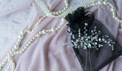 Wedding background with pearls and hair accessories on pink background