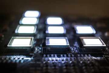 The process of checking several oled displays on the test station. Displays glow brightly.